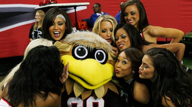 In this file photo, Freddie Falcon shows why he’s the (bird)man of football mascots as he’s swarmed by Falcons cheerleaders. In a battle of the birds, a falcon has it all over Seattle’s seahawk. Curtis Compton, ccompton@ajc.com
