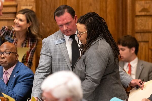 State Sen. Clint Dixon, R-Gwinnett, and State Sen. Kim Jackson, D-Stone Mountain, speak together during a discussion on HB 150, a bill regarding China and Georgia universities, at the Senate in the Capitol in Atlanta on Monday, March 31, 2025. (Arvin Temkar / AJC)