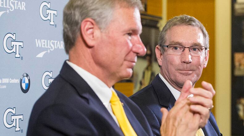 Todd Stansbury, right, is announced as the new athletic director at Georgia Tech by school President Bud Peterson during a news conference, Thursday, Sept. 22, 2016, in Atlanta. Stansbury had served as Oregon State's athletic director since June 2015 and is a former Georgia Tech football player and 1984 alumnus. (AP Photo/John Amis)