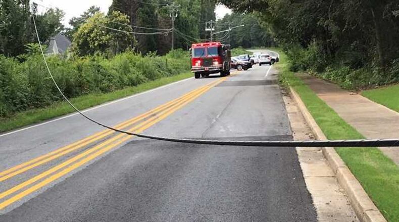 A road in north Fulton County is closed Thursday after a power line fell, blocking the road.