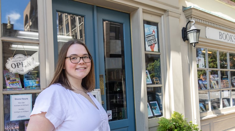 Lauren Colby, 19, said she's “dreading more than looking forward to” her first vote in a presidential election. poses for a photo in front of the bookstore she works at on Wednesday, June 12, 2024 in Savannah, GA. (AJC Photo/Katelyn Myrick)