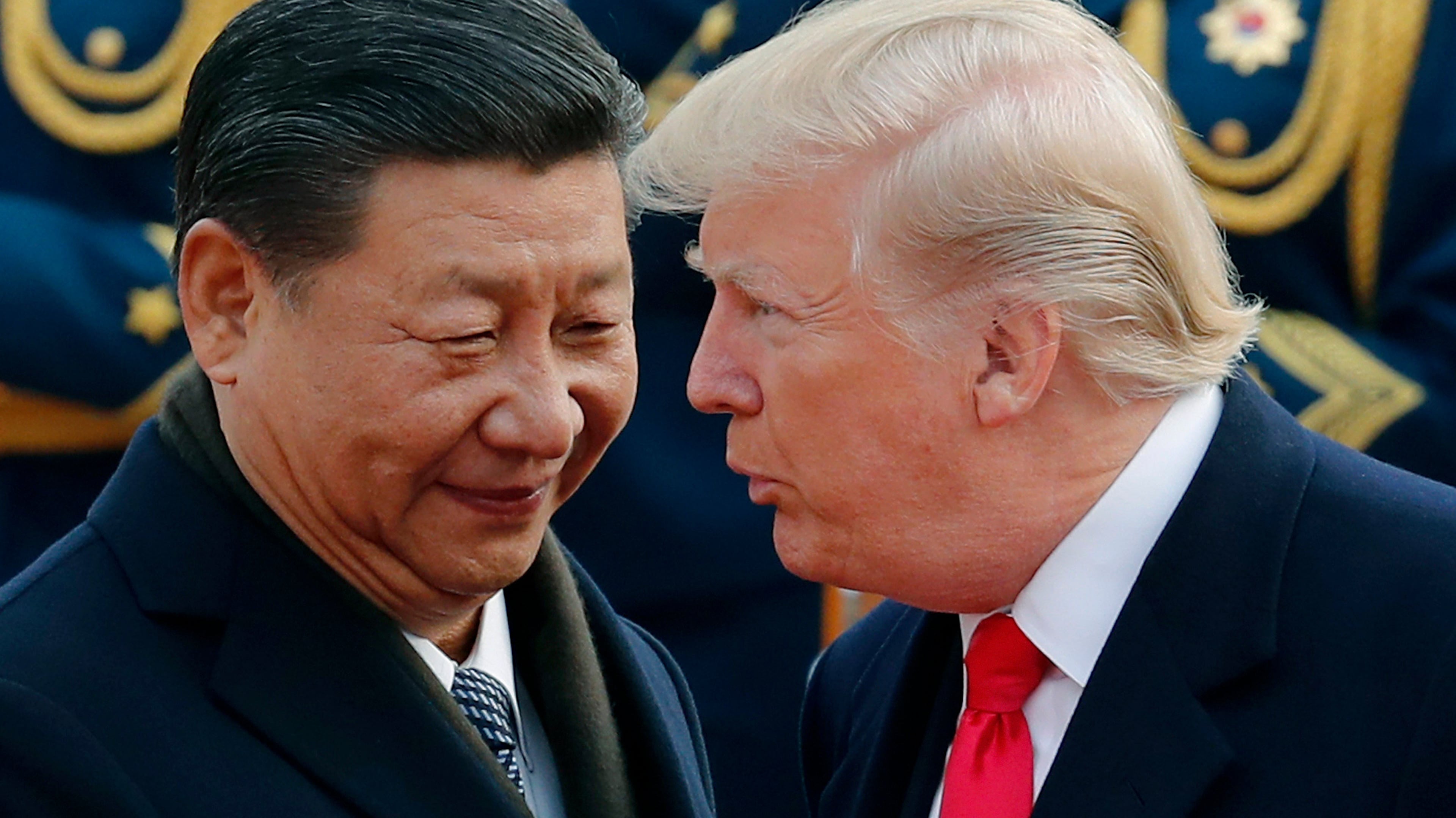 FILE - In this Nov. 9, 2017, file photo, U.S. President Donald Trump, right, chats with Chinese President Xi Jinping during a welcome ceremony at the Great Hall of the People in Beijing. (AP Photo/Andy Wong, File)
