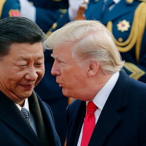 FILE - In this Nov. 9, 2017, file photo, U.S. President Donald Trump, right, chats with Chinese President Xi Jinping during a welcome ceremony at the Great Hall of the People in Beijing. (AP Photo/Andy Wong, File)