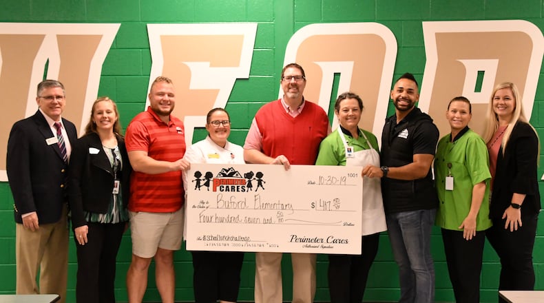 Buford City Schools received a donation from Perimeter Roofing to cover costs of student lunch debt. COURTESY OF BUFORD CITY SCHOOLS