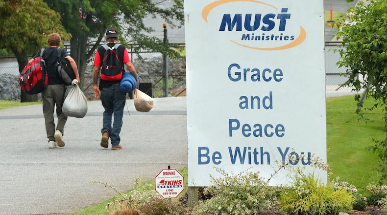 A pair of homeless men head out for the day after getting some assistance at MUST Ministries on Wednesday, August 9, 2017, in Cobb County.   Curtis Compton/ccompton@ajc.com