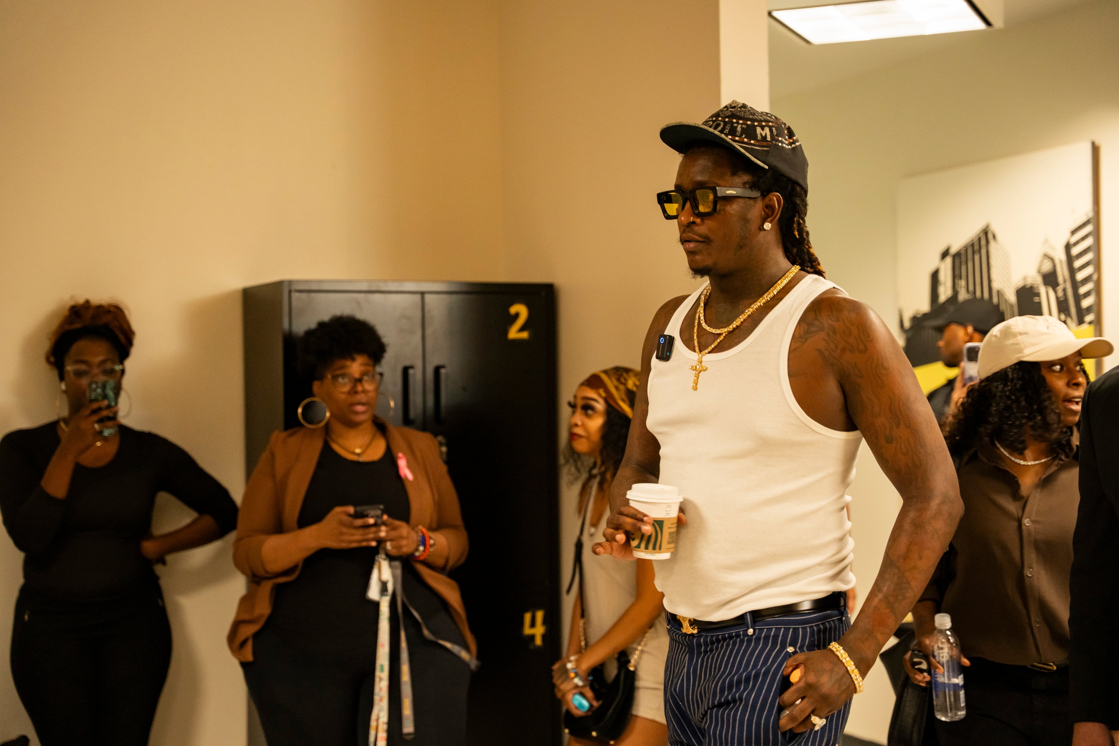 Jeffery Williams, known as rapper Young Thug, enters  Skyview High School as students and faculty look on in surprise, Friday, Aug. 1, 2025, in Atlanta. The visit is part of his court-mandated anti-gang outreach, one of the few conditions under which he is allowed in the city. (Olivia Bowdoin for the AJC)