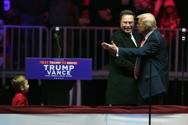 FILE - Elon Musk, with his son X Æ A-Xii, arrives on the dais with President-elect Donald Trump, at a rally ahead of the 60th Presidential Inauguration, Jan. 19, 2025, in Washington. (AP Photo/Matt Rourke, File)