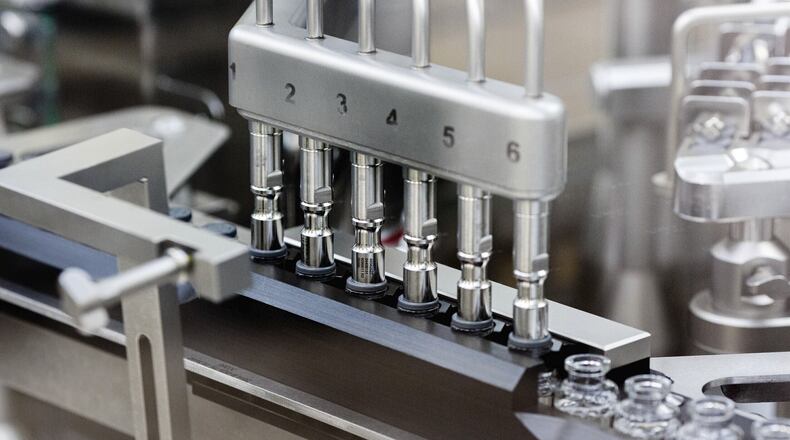 In this March 2020 photo provided by Gilead Sciences, rubber stoppers are placed onto filled vials of the investigational drug remdesivir at a Gilead manufacturing site in the United States. Given through an IV, the medication is designed to interfere with an enzyme that reproduces viral genetic material. GILEAD SCIENCES VIA AP