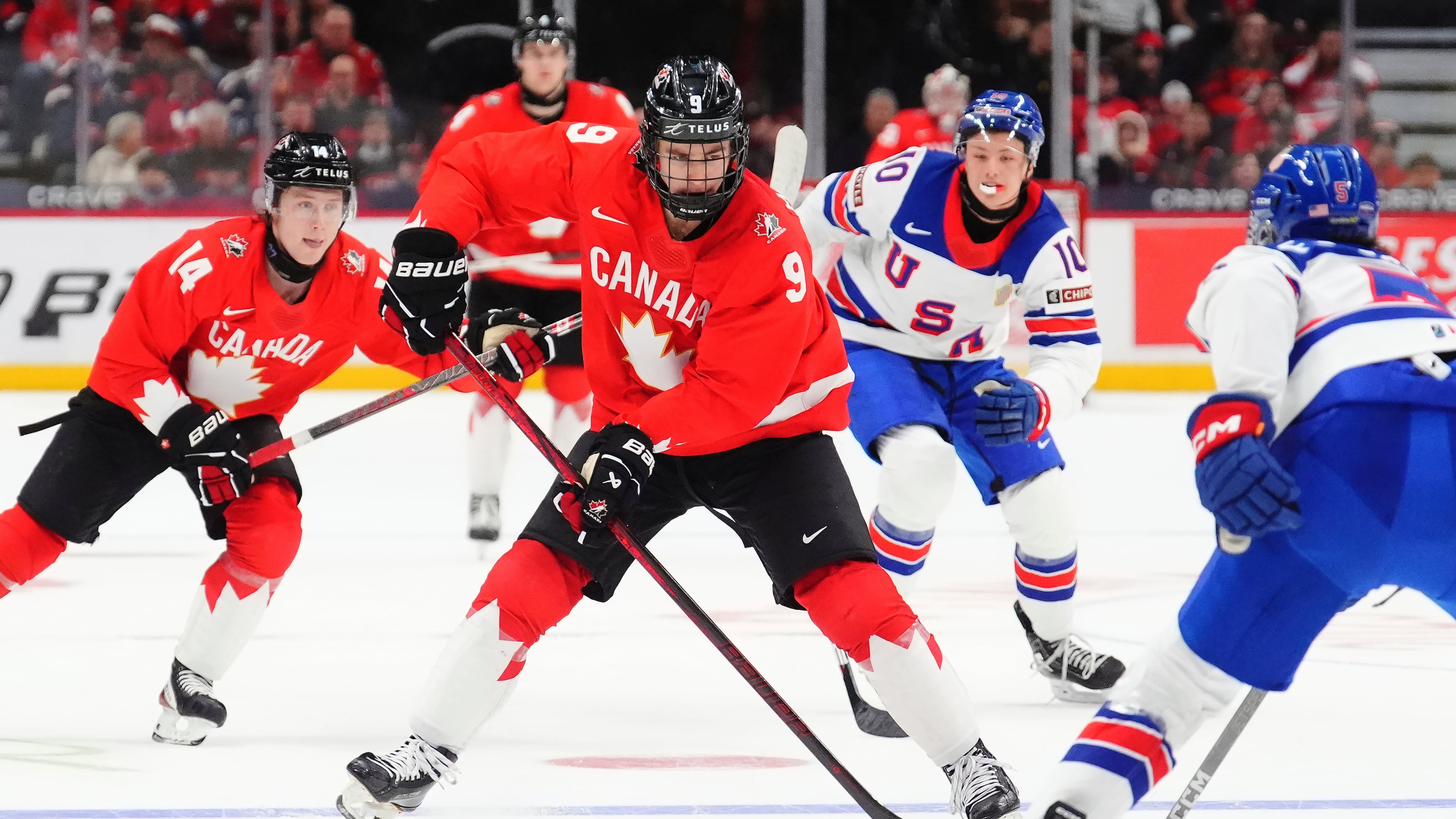FILE - Canada's Gavin McKenna (9) skates with the puck as United States' Drew Fortescue (5) defends during the second period of an IIHF World Junior Hockey Championship tournament game in Ottawa, Ontario, Dec. 31, 2024. (Sean Kilpatrick/The Canadian Press via AP, File)