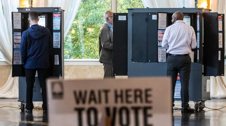 Voters cast ballots on May 21 at the polling place at the Park Tavern in Atlanta. (John Spink/AJC)
