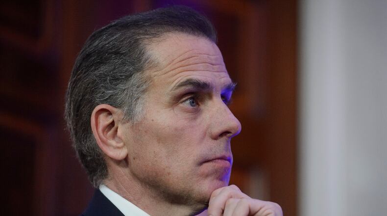 FILE - Hunter Biden listens while his father, President Joe Biden, speaks during a Hanukkah reception in the East Room of the White House in Washington, Dec. 16, 2024. (AP Photo/Rod Lamkey, Jr., File)