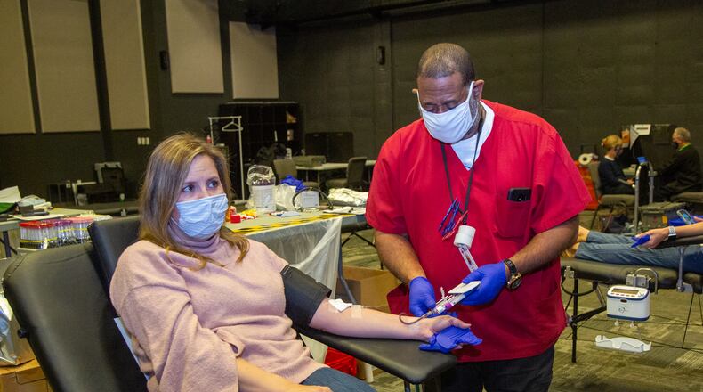 Ricky Green (right) draws blood samples from reporter Keri Janton as she donates blood at a Red Cross drive at Gwinnett Church in Sugar Hill on Monday April 12th, 2021.
PHIL SKINNER FOR THE ATLANTA JOURNAL-CONSTITUTION.
