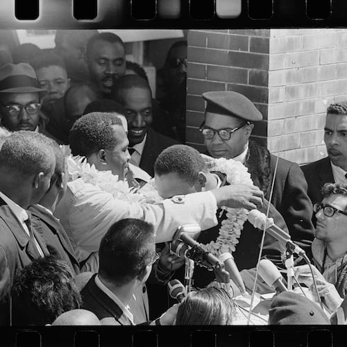 This photo provided by Jeannine Herron shows Charles Campbell, who traveled to Alabama for the march from Selma to Montgomery, placing a lei on Dr. Martin Luther King, Jr. at Brown Chapel AME in Selma, Ala., March 21, 1965. (Matt Herron/Jeannine Herron/Dept. of Special Collections and University Archives, Stanford University Libraries via AP)