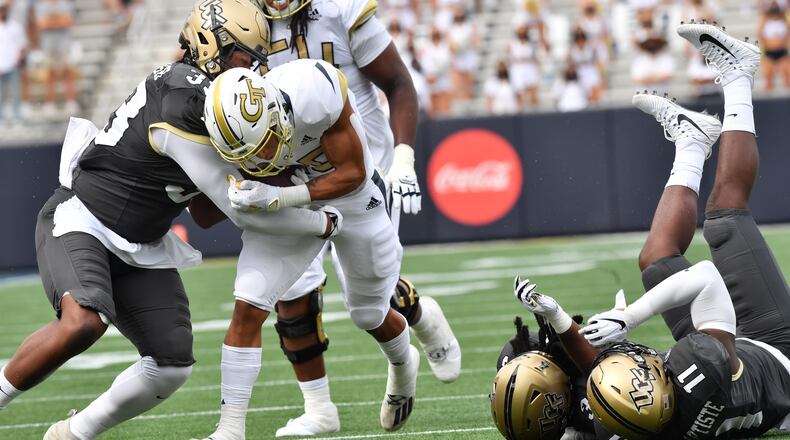 September 19, 2020 Atlanta - Georgia Tech's running back Dontae Smith (28) gets tackled by University of Central Florida's defensive lineman Tre'mon Morris-Brash (left) during the first half of an NCAA college football game at Georgia Tech's Bobby Dodd Stadium in Atlanta on Saturday, September 19, 2020. (Hyosub Shin / Hyosub.Shin@ajc.com)