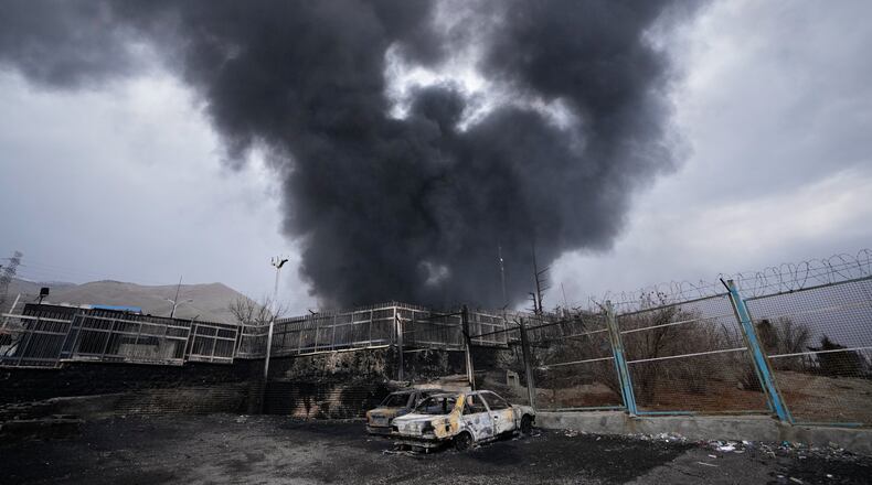 FILE - A thick plume of smoke rises from an oil storage facility hit by a U.S.-Israeli strike in Tehran, Iran, March 8, 2026. (AP Photo/Vahid Salemi, File)