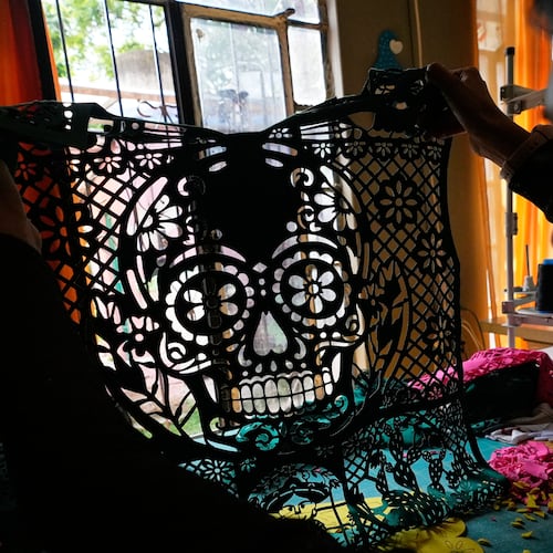 Cande Martinez prepares soccer jerseys, inspired by papel picado and traditional folk art, from the brand Mexclart, in Cuautitlán Izcalli, Mexico, Monday, May 25, 2026. (AP Photo/Marco Ugarte)