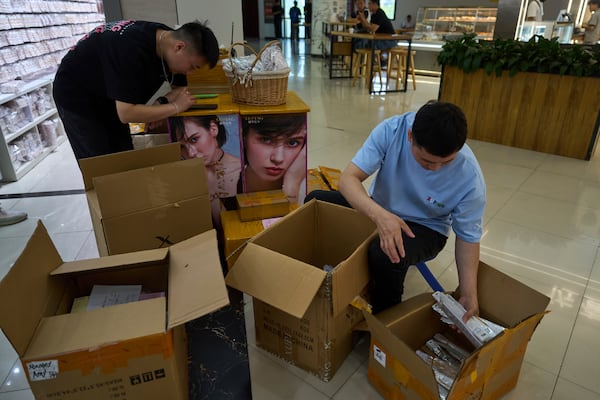 Workers pack fashion accessories for delivery at the Yiwu International Trade Market in Yiwu, eastern China's Zhejiang province on Thursday, April 10, 2025. (AP Photo/Ng Han Guan)