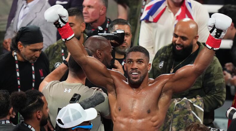 FILE - Anthony Joshua reacts after defeating Jake Paul in their heavyweight boxing match, Friday, Dec. 19, 2025, in Miami. (AP Photo/Lynne Sladky, File)