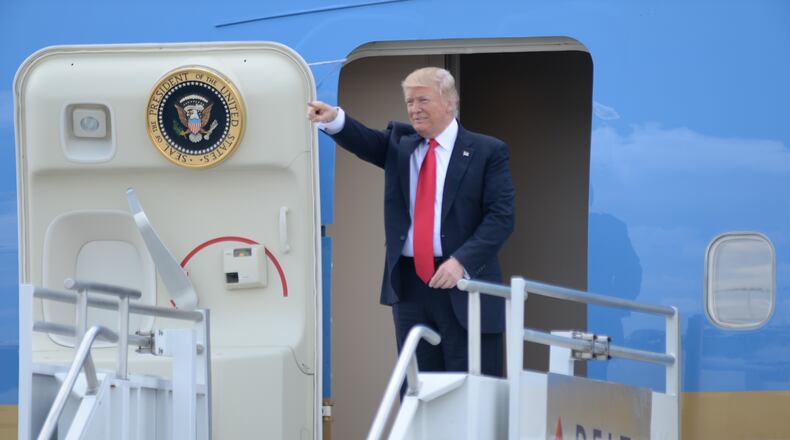 President Donald Trump waves at a crowd of people waiting as he arrives at Hartsfield Jackson International Airport, aboard Air Force One, Friday April 28, 2017. KENT D. JOHNSON/ kdjohnson@ajc.com