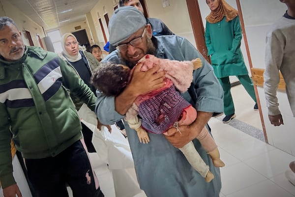 Nashat Seiam carries the body of his granddaughter Ahlam Seiam, who was just days away from her first birthday, into Nasser Hospital, after their home was hit by an overnight Israeli airstrike in Khan Younis, southern Gaza Strip, on Wednesday, April 16, 2025.(AP Photo/Mariam Dagga)