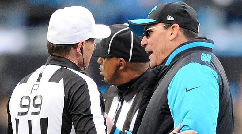 Carolina Panthers head coach Ron Rivera speaks to referee Tony Corrente (99) during the second half of an NFL divisional playoff football game against the Seattle Seahawks, Sunday, Jan. 17, 2016, in Charlotte, N.C. (AP Photo/Mike McCarn)