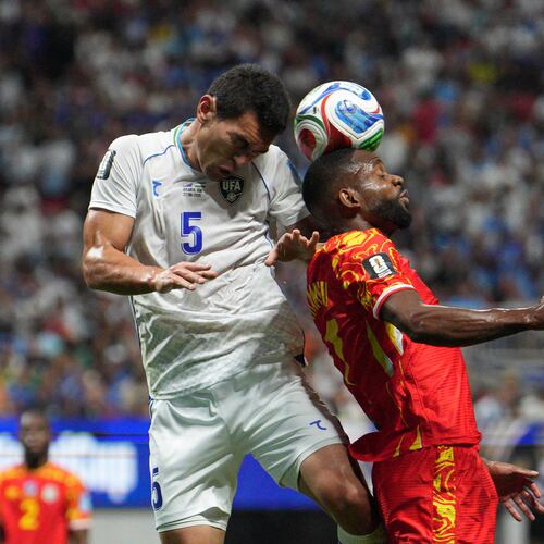 Uzbekistan's Rustam Ashurmatov (5) and Congo's Cedric Bakambu, right, collide as they try to head the ball during the first half of the World Cup Group K soccer match between DR Congo and Uzbekistan in Atlanta, Saturday, June 27, 2026. (AP Photo/Jacob Kupferman)