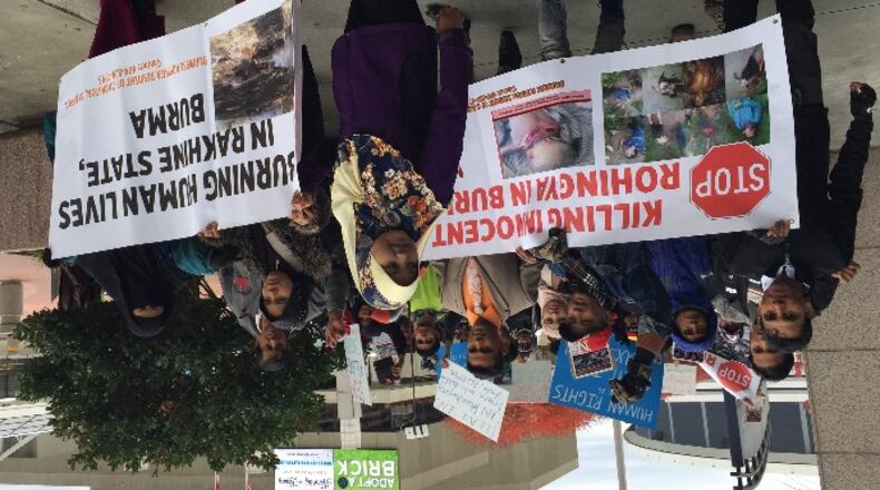 Protesters marched around the CNN Center in downtown Atlanta Saturday, calling for an end to the deadly violence targeting the Rohingya, a stateless Muslim minority that is being driven out of its predominantly Buddhist homeland of Myanmar. JEREMY REDMON/jredmon@ajc.com