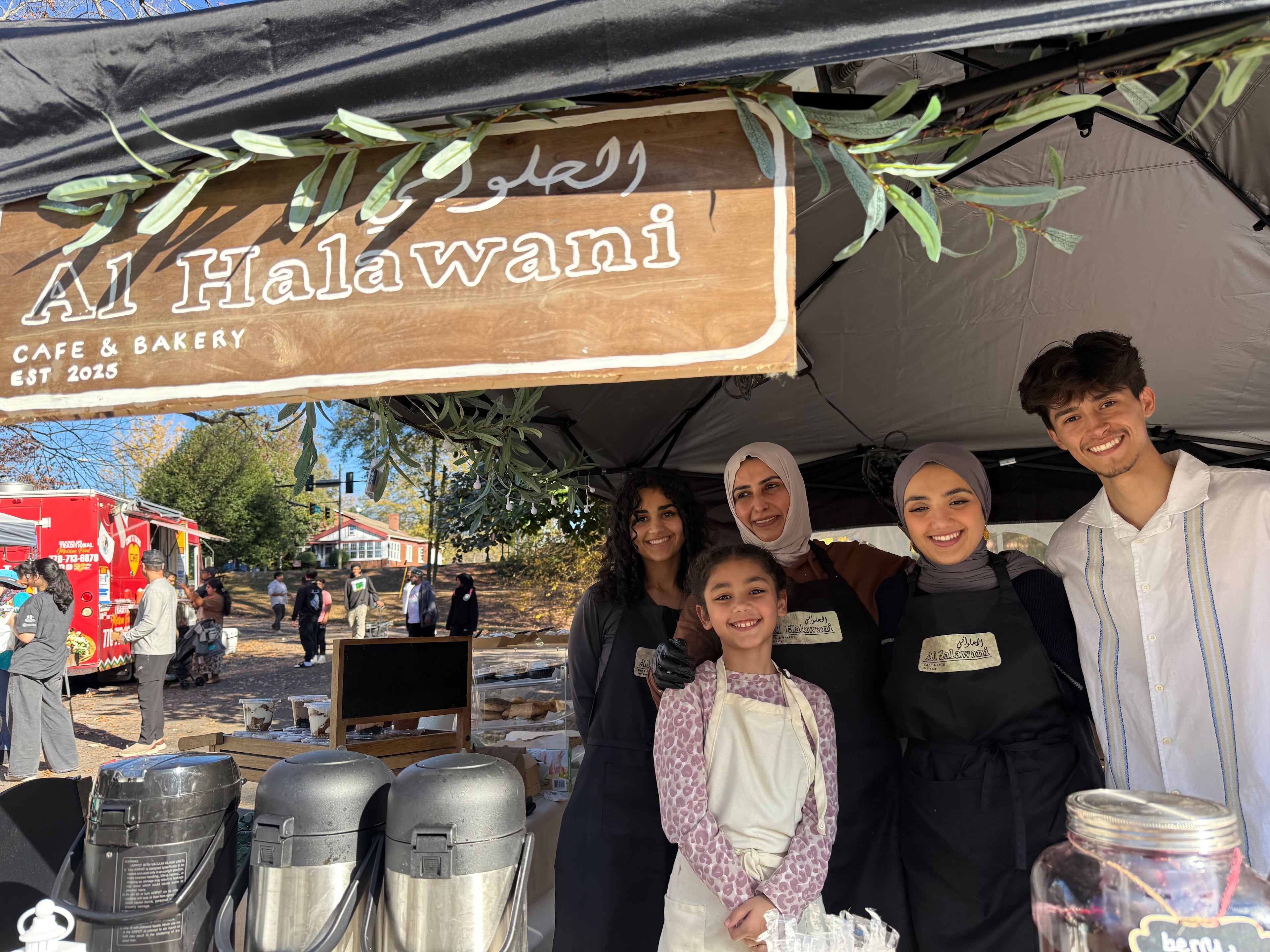 In this photo, Ekhlass Gzar poses with her family at a desserts stall her family set up for the first time to try out her dream of owning a restaurant. Gzar's daughters just made the stall's sign themselves (they call the business Al Halawani) from an old coffee table. The Atlanta Halal Fall Festival opened at noon Saturday and Sunday under a bright blue sky in Grant Park near downtown Atlanta, in what organizers hope will become a city tradition.
A brisk crowd sampled pastries, meat sandwiches, coffees, and desserts from Muslim traditions across the globe, and shopped for jewelry and crafts. Photos show the festival on Sunday, November 23, 2025 in Grant Park in Atlanta. Photo by Ariel Hart ahart@ajc.com.