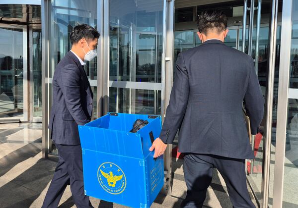 FILE - South Korean police officers arrive for the search and seizure at the office of former Defense Minister Kim Yong Hyun at the Defense Ministry in Seoul, South Korea, on Dec. 8, 2024. (Kim Chul-sun/Yonhap via AP, File)