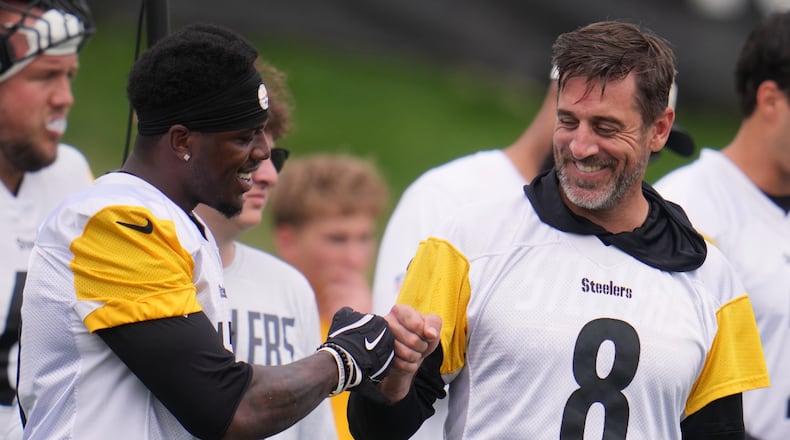Pittsburgh Steelers quarterback Aaron Rodgers (8) fist bumps wide receiver Germie Bernard, left during the NFL team's training camp in Latrobe, Pa., Saturday, Aug. 1, 2026. (AP Photo/Gene J. Puskar)