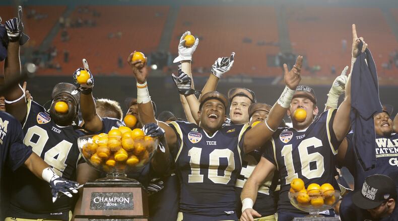 Georgia Tech players celebrate with their trophy after Georgia Tech defeated Mississippi State 49-34 in the Orange Bowl NCAA college football game, Wednesday, Dec. 31, 2014 in Miami Gardens, Fla. (AP Photo/Wilfredo Lee) Georgia Tech football players and other scholarship athletes will begin receiving stipends worth about $1,600 starting next school year. (ASSOCIATED PRESS)
