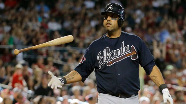 Atlanta Braves' Gerald Laird flips his bat after striking out with the bases loaded to end the eighth inning of a baseball against the Arizona Diamondbacks, Sunday, June 8, 2014, in Phoenix. (AP Photo/Matt York)