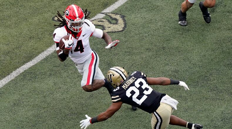 Vanderbilt cornerback Jaylen Mahoney (23) closes in on Georgia running back James Cook (4) in the first half of an NCAA college football game Saturday, Sept. 25, 2021, in Nashville, Tenn. (AP Photo/Mark Humphrey)