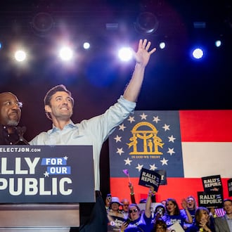 U.S. Sen. Raphael Warnock, left, introduces U.S. Sen. Jon Ossoff, right, to the stage during a “Rally for the Republic” at The Eastern on Saturday, March 22, 2025. Both senators are Georgia Democrats. (Jenni Girtman for The Atlanta Journal-Constitution)