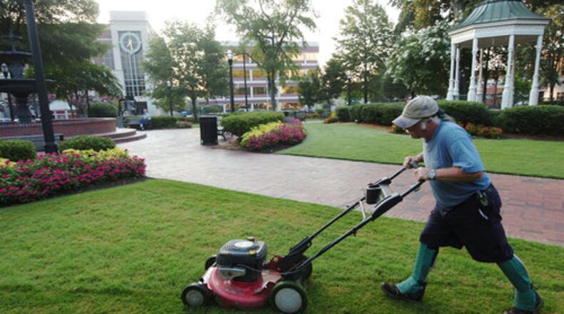 Among the employees needed in Marietta are people who will mow the lawn at Glover Park, the centerpiece of Marietta Square. AJC file photo