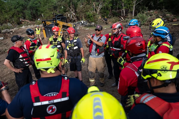 A crew of firefighters from Ciudad Acuna gather for a briefing as they aid in search and rescue efforts near the Guadalupe River after a flash flood swept through the area Monday, July 7, 2025, in Ingram, Texas. (AP Photo/Eli Hartman)