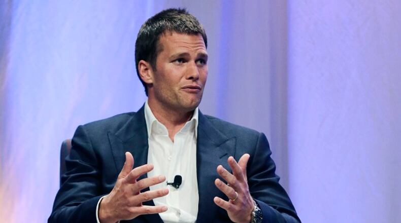 FILE - In this May 7, 2015, file photo, New England Patriots quarterback Tom Brady gestures during an event at Salem State University in Salem, Mass. Brady's four-game suspension for his role in using underinflated footballs during the AFC championship game last season has been upheld by NFL Commissioner Roger Goodell. The league announced the decision Tuesday, July 28, 2015. (AP Photo/Charles Krupa, Pool)