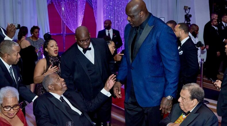 Shaquille O'Neal greets Hank Aaron at a UNCF Mayor's Masked Ball fundraiser in Atlanta.
