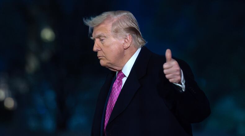 President Donald Trump waves to the media as he walks on the South Lawn upon his arrival to the White House, Sunday, March 29, 2026, in Washington. (AP Photo/Jose Luis Magana)