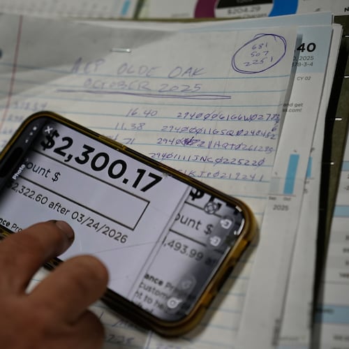 FILE - Eric Pinson, manager and resident of the Lock 24 RV Park and Campground, one of two such locations he manages in the area, looks over the business' electric bills, at his home at the campground in Racine, Ohio, March 13, 2026. (AP Photo/Carolyn Kaster, File)