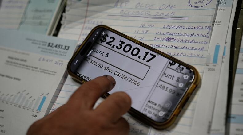FILE - Eric Pinson, manager and resident of the Lock 24 RV Park and Campground, one of two such locations he manages in the area, looks over the business' electric bills, at his home at the campground in Racine, Ohio, March 13, 2026. (AP Photo/Carolyn Kaster, File)