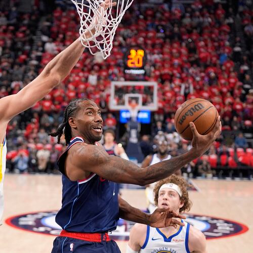 FILE - LA Clippers forward Kawhi Leonard, center, shoots as Golden State Warriors center Kristaps Porzingis defends during the first half of an NBA play-in tournament basketball game Wednesday, April 15, 2026, in Inglewood, Calif. (AP Photo/Mark J. Terrill,File)
