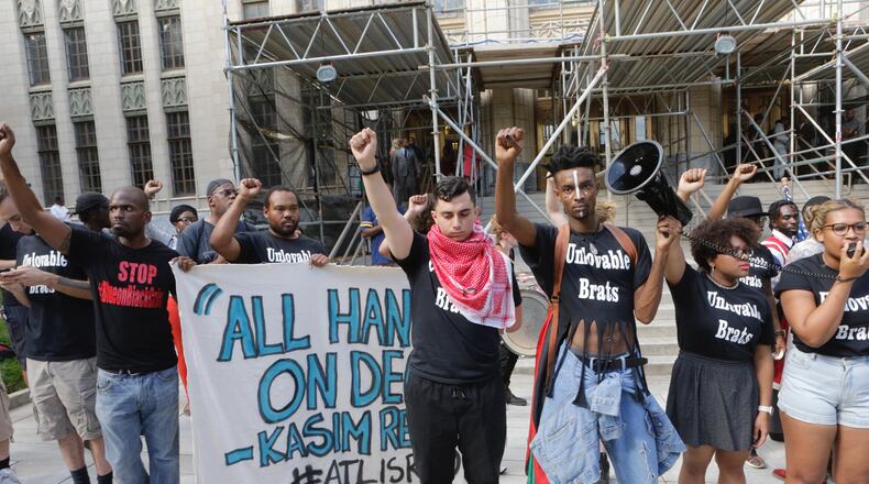 Black Lives Matter protesters outside of Atlanta City Hall chant while displaying a banner reading "All hands on deck -- Kasim Reed." The banner refers to a June 29 press conference in which Mayor Reed said of his plan to reduce crime in the city, "As mayor of the city of Atlanta, public safety is my No. 1 priority. It's a vigorous and detailed plan, but it can be simply summed up: It's all hands on deck."