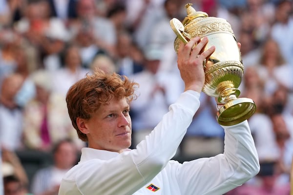 Jannik Sinner of Italy holds the trophy after winning the men's singles final match against Carlos Alcaraz of Spain at the Wimbledon Tennis Championships in London, Sunday, July 13, 2025.(AP Photo/Kirsty Wigglesworth)