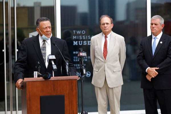 Mississippi Lt. Gov. Delbert Hosemann, center, and House Speaker Philip Gunn, R-Clinton, listen as Reuben Anderson, chairman of the board of the Mississippi Department of Archives and History, speaks about the retired Mississippi state flag during its retirement ceremony at Two Mississippi Museums in Jackson, Miss., Wednesday, July 1, 2020. (AP Photo/Rogelio V. Solis)