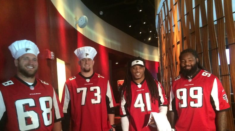 On Oct. 4, Atlanta Falcons players (from left) Mike Person, Ryan Schraeder, Philip Wheeler and Adrian Clayborn participated in a cook-off with culinary students.