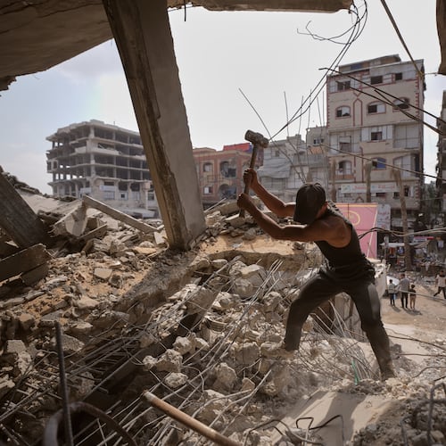 Palestinians remove iron from the rubble of buildings destroyed by Israeli airstrikes during the war with Hamas, repair and recycle it for construction, building tents or selling it, in Gaza City, Sunday, Aug. 16, 2026. (AP Photo/Jehad Alshrafi)