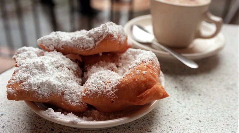 A favorite treat in New Orleans is beignets and coffee, shown here at the famous Cafe du Monde on Tuesday, January, 13, 1998. (AJC file)