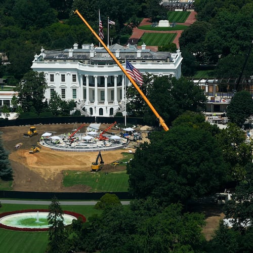 Workers build a helipad on the South Lawn of the White House, left, and continue construction on the new White House ballroom, right, as seen from the Washington Monument, Monday, Aug. 17, 2026, in Washington. (AP Photo/Julia Demaree Nikhinson)