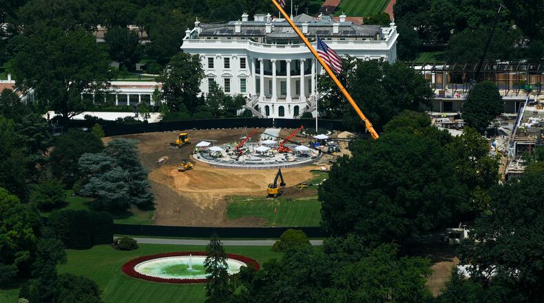 Workers build a helipad on the South Lawn of the White House, left, and continue construction on the new White House ballroom, right, as seen from the Washington Monument, Monday, Aug. 17, 2026, in Washington. (AP Photo/Julia Demaree Nikhinson)